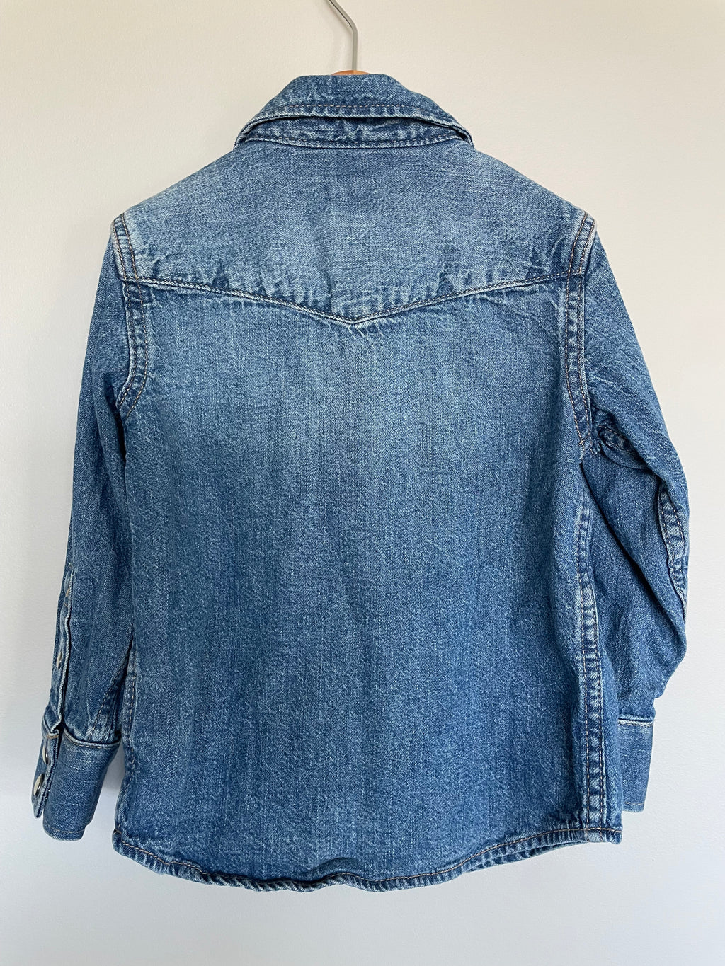 Blue denim jacket on a white background