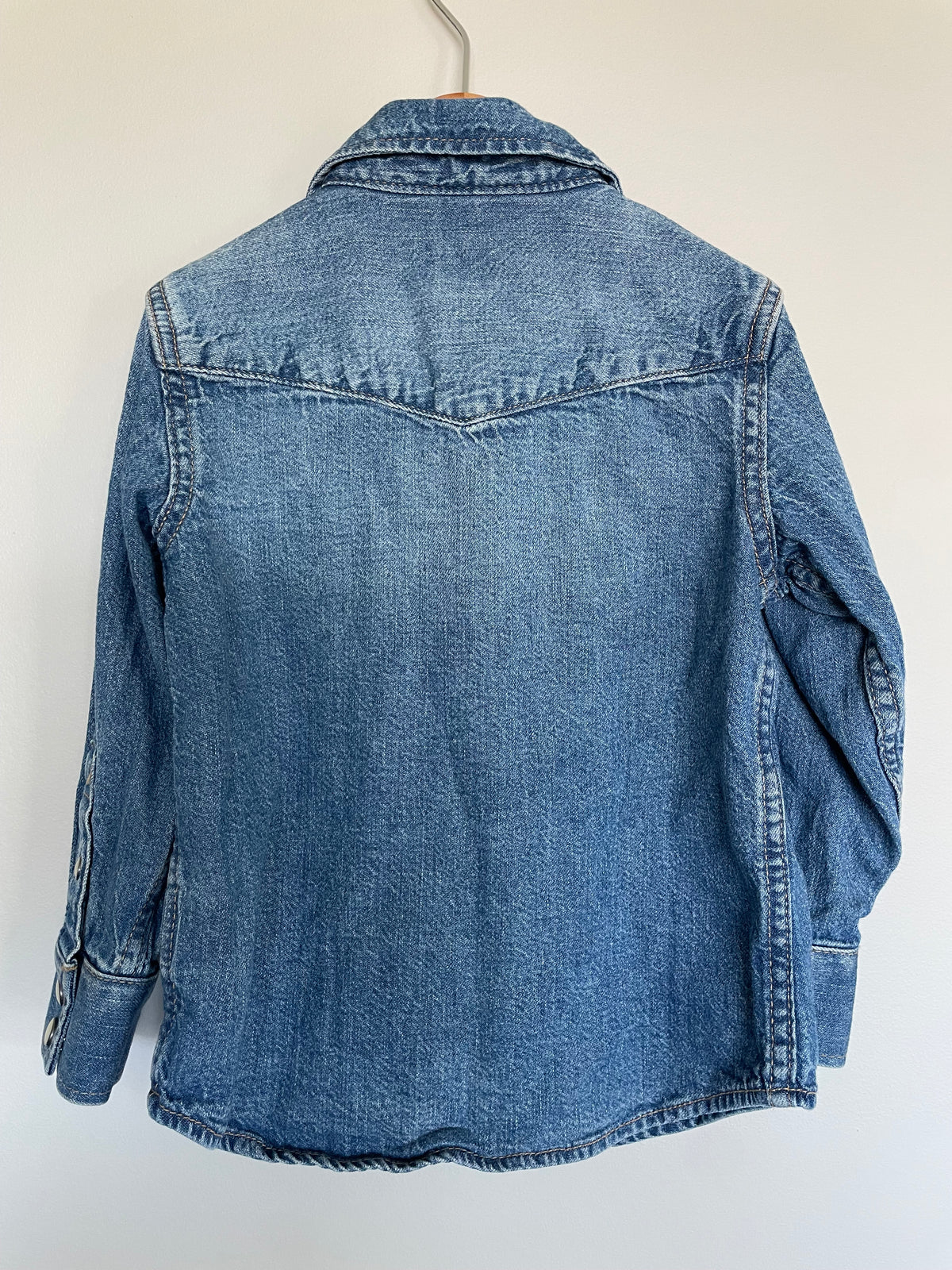 Blue denim jacket on a white background